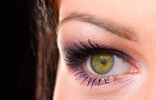 Women's  green eye macro with purple makeup