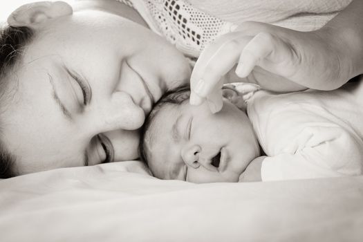 Sleep baby with mom, closeup faces