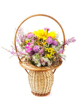 Bouquet of wild flowers and sunflowers in basket isolated