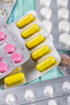 A variety of tablets in packs on background, treatment