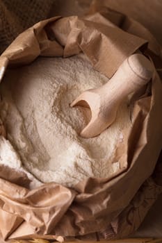 Meal in sack with wooden spoon closeup