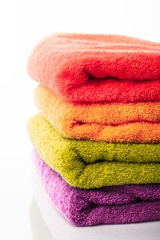 Stack of colorfull towels isolated on white