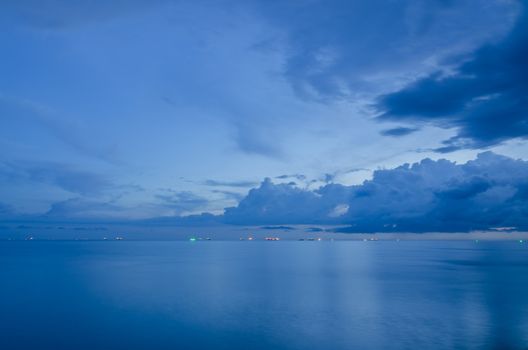 Oil tanker ships still anchor at the bay after rain as blue sky