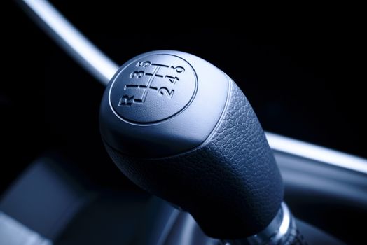 Interior of car, vehicle with visible lever of manual  transmission, with metal, chrome elements.