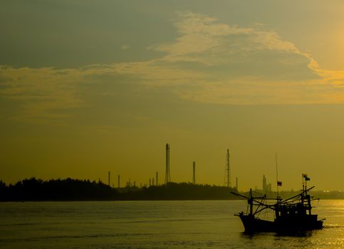 Refinery heavy industrial  effect with lifestyle of small boat fisherman