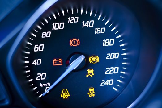 Photo presents car's, vehicle's speedometer or tachometer with visible information display - ignition warning lamp  and brake system warning lamp, visible symbols of instrument cluster ( ten check warning light), with warning lamps illuminated.