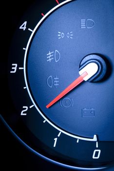 Photo presents car's, vehicle's speedometer or tachometer with visible information display - ignition warning lamp  and brake system warning lamp, visible symbols of instrument cluster ( ten check warning light).