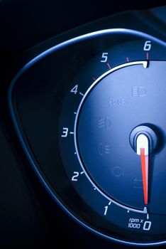 Photo presents car's, vehicle's speedometer or tachometer with visible information display - ignition warning lamp  and brake system warning lamp, visible symbols of instrument cluster ( ten check warning light).