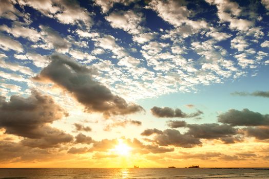 Sunrise with sun rays and clouds