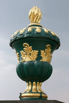 Green and gold vase with lid and ornaments