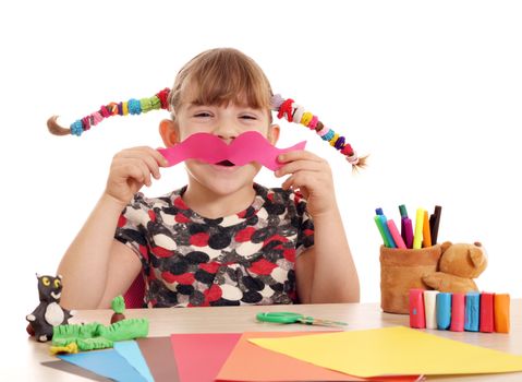 little girl makes paper mustache