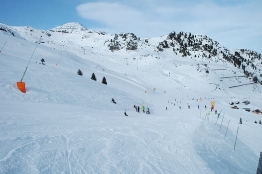 Slope and skiers in Alps nearby Kaltenbach in Zillertal valley in Austria