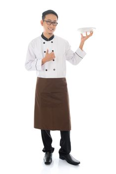 Full body Asian chef holding an empty plate ready for food, thumb up and standing isolated on white background.