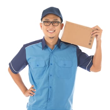 Delivery person delivering package smiling happy in blue uniform. Handsome young Asian man professional courier isolated on white background.