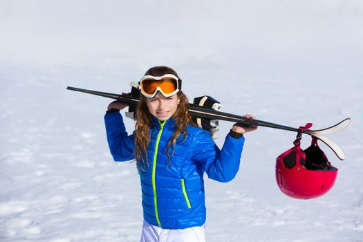 Kid girl winter snow holding ski equipment helmet goggles