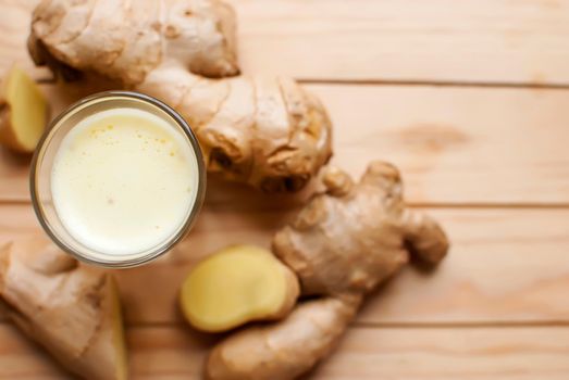 fresh organic healthy ginger shot juice and root