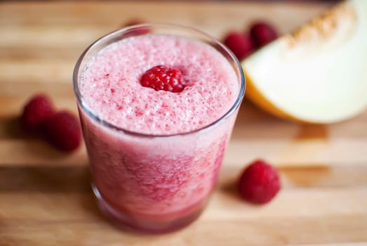 healthy raspberry and melon juice over wood