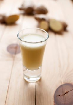 fresh organic healthy ginger shot juice and root