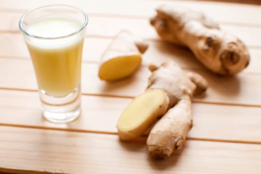 fresh organic healthy ginger shot juice and root