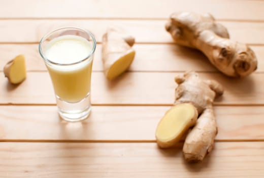 fresh organic healthy ginger shot juice and root