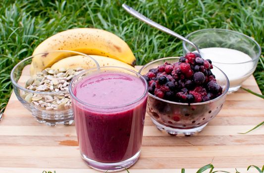 healthy berries juice smootie on wooden board