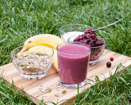 healthy berries juice smootie on wooden board