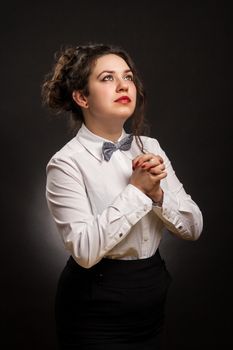 adult stylish woman praying, with dark background