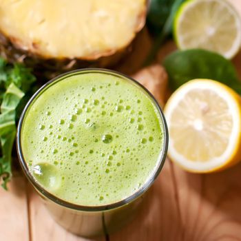 healthy organic green detox juice on wood