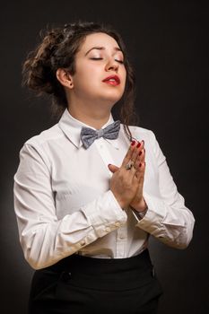 adult stylish woman praying, with dark background