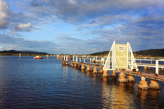 Ducks rest on a dilapidated old timber jetty in the late afternoon, Woy Woy, Australia, 