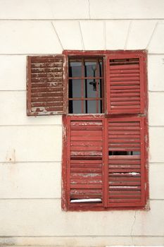 old damaged wooden blinds on an abandoned house