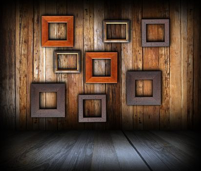 wooden interior background with empty  frames on wall for your message or advertising