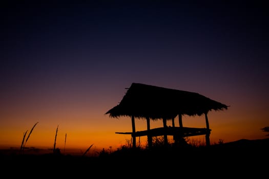 hut in silhouette style in the evening before sunset