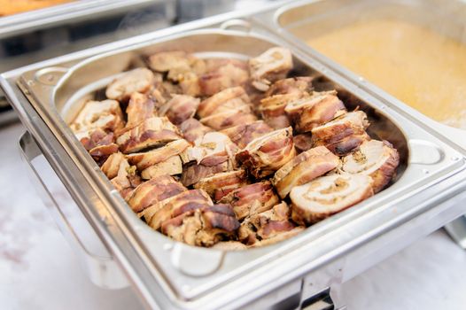 Pieces of pork roulade in a silver tray