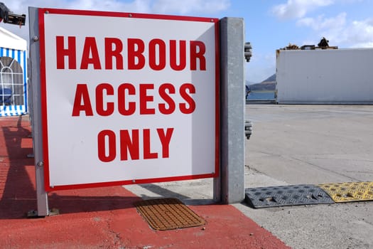 A sign with a white background and the words 'HARBOUR ACCESS ONLY' written in red.