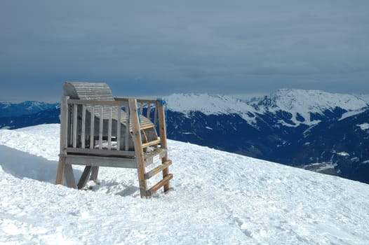 Big wooden chair on ofelerjoch peak in Austria nearby Kaltenbach in Zillertal valley