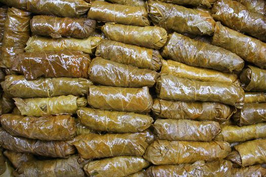 Turkish stuffed grape leaves with ground beef, mint, parsley, rice, onion, tomatoes and spices