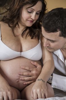 Mom, Family With Pregnant Mother Relaxing On bed Together