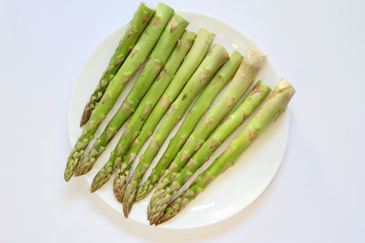 Green vegetable Asparagus bundle in a white plate