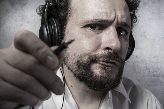 Jack, listening and enjoying music with headphones, man in white shirt with funny expressions