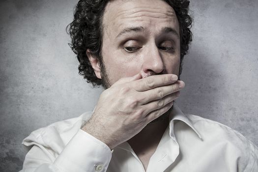 Businessman covering his emouth, man in white shirt with funny expressions