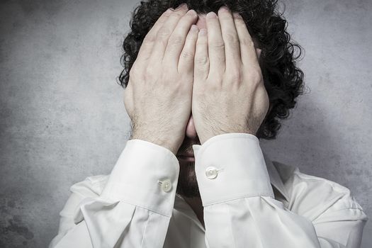 Businessman covering his eyes, man in white shirt with funny expressions