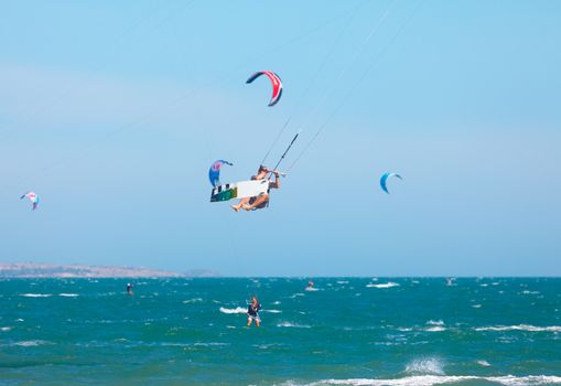 MUI NE, VIETNAM - JANUARY 31, 2014: Unidentified kitesurfer at Mui Ne resort beach on January 31, 2014 in Mui Ne resort, Vietnam.