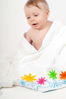 Baby boy in a white floral towel