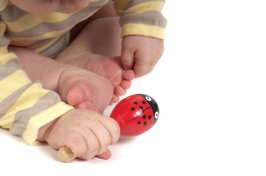 Baby keeping red toy in the hand