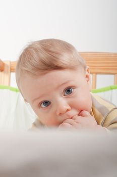 Cute baby boy in cradle watching on you