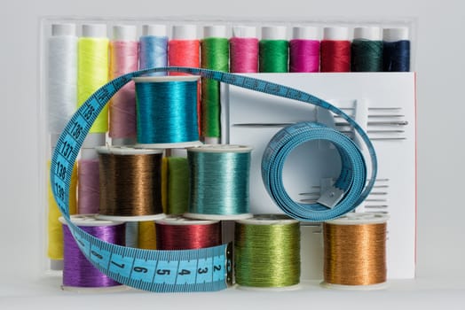 Coils with color strings of various color, sewing needles and sartorial centimeter