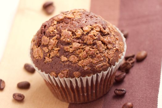 Chocolate muffins and coffee beans on the table