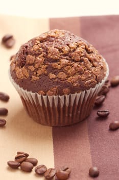 Chocolate muffins and coffee beans on the table