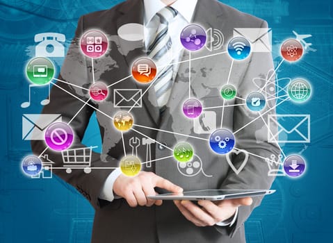 Man in suit holding tablet pc and application icons in hand. The concept of software